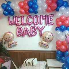 A classic "Welcome Baby" wall decoration. I use pink foil letter balloons, baby-shaped foil balloons, and a simple balloon arch in red, white, and blue for a cheerful and direct welcome message.