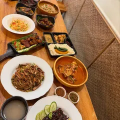 A New Year's feast spread across the table at Naga Belly. We love starting the year by sharing an abundance of good food with our community.