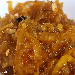 A close-up of the texture of my Aam ki Chutney. You can see the grated mango shreds and whole spices. It's a chunky, flavourful chutney that is perfect with roti or bread.