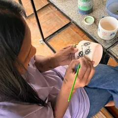 This student is adding a quirky, creative design to her mug. The glazing and painting stage is where each piece truly becomes one-of-a-kind.