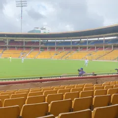 The view from the stands at the M. Chinnaswamy Stadium during a Ranji Trophy match. This is the stage our players work towards, and we are proud to see them make their debut here.