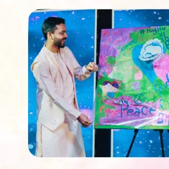 The groom participates in a "Wow Magic Portrait" activity. This unique experience involves guests contributing to a painting that later magically reveals a portrait of the couple, creating a collaborative and surprising piece of art.