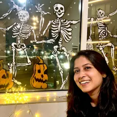 Me with our spooky, hand-painted Halloween window display. It was so much fun to create this and see people's reactions.
