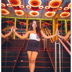 A guest posing in the iconic mirrored stairway at 'One Night in Bangkok'. The venue has a vibe as unique as the music.