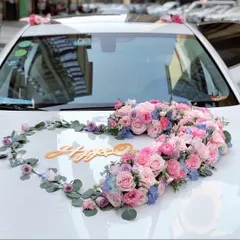 A beautiful heart-shaped floral arrangement for a wedding car. We used a mix of pink and blue roses and other delicate flowers to create a romantic decoration for the couple's getaway car.