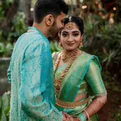 A tender moment between the couple, showcasing their beautiful traditional attire. This portrait highlights the intricate details of the bride's jewelry and the soft connection they share.