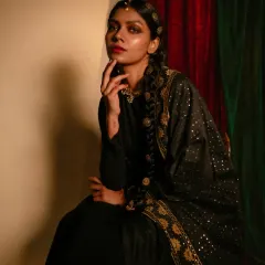 From the 'Amodini' series, this portrait blends traditional and modern aesthetics. I styled a simple black dress with an ornate dupatta and traditional hair jewelry to create a look of timeless elegance.