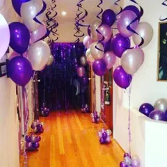 I can decorate any part of your home, including hallways. This purple and silver balloon arrangement with streamers creates a festive pathway to the main party area.