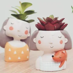 For a gift that's full of personality, I offer these quirky and adorable mini planters. They are perfect for housing small succulents and make for a delightful desk companion or a thoughtful personal gift that is sure to bring a smile. This one holding a little fox is a particular favorite.