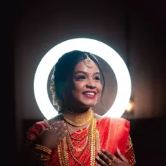 A creative bridal portrait using a ring light to frame her happy face, highlighting her smile and stunning jewelry.