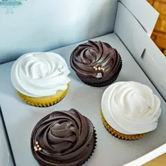 Sometimes, simple is best. This classic box of four cupcakes, with two vanilla and two chocolate, features elegant swirls of frosting and a touch of edible glitter, making for a perfect little gift.