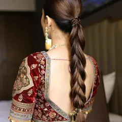 A sleek and powerful braided ponytail, perfect for a modern bride who wants a statement hairstyle for her wedding or reception.