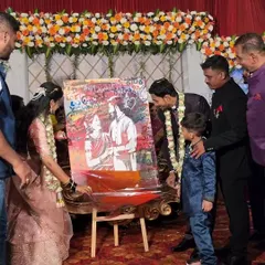 Here, the couple is adding their own touch to the canvas. This interactive element makes the artwork even more personal, turning it into a collaborative keepsake from their wedding reception.