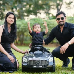 A stylish family portrait taken outdoors with their son and his favorite toy car. I love coordinating outfits and props to create a cohesive and polished family photo.