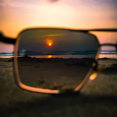 I love finding new perspectives. Here, I used a pair of sunglasses to frame the setting sun, creating a unique reflection and a photo within a photo.