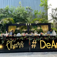 This is our classic black and gold wedding bar setup, perfect for an elegant cocktail party. We customize the bar front with details like the event hashtag, making it a central feature of your celebration.