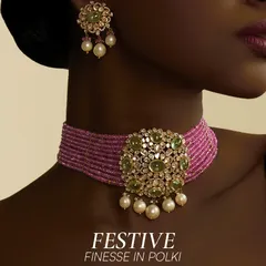 A vivid pink beaded choker crowned with a floral Polki medallion. This piece brings together green cabochons and soft pearl drops for a festive, heirloom glow.