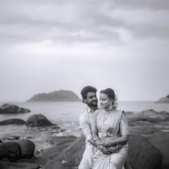 A timeless black and white portrait from a destination wedding. The rocky shore and the endless sea provide a powerful, classic backdrop for this quiet moment of togetherness.