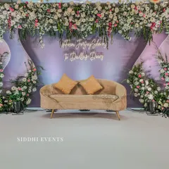 We brought this couple's long-distance love story to life with a personalized neon sign and a modern, elegant stage design, blending soft lavender with lush florals for their engagement.