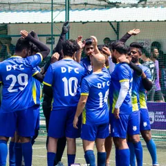 A team in blue jerseys gathers for a huddle, planning their next move. Our venues are home to countless moments of teamwork and sportsmanship.