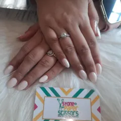 A clean and simple set of solid off-white nails. This color is a perfect neutral that looks fresh and modern on these classic almond-shaped extensions.