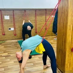 The wall ropes provide incredible support for deep backbends like this Urdhva Dhanurasana (Wheel Pose), helping to open the spine and shoulders more fully.