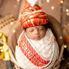 A portrait of a little 'Raje' in the style of Chhatrapati Shivaji Maharaj. We use a custom turban, pearl necklaces, and a miniature sword to create a look of tiny royalty.