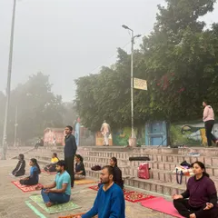 A wider view of our meditation session by the river, showing the peaceful coexistence of our practice with the life of the holy city.
