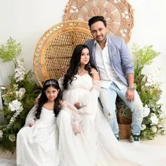 A perfect family portrait in our boho-chic setup. I love including older siblings and coordinating outfits, like this mother-daughter duo in matching white gowns, to create sweet, connected memories.