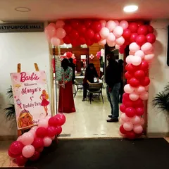 The entrance to Anaya's Barbie party featured a beautiful pink and red organic balloon arch and a custom welcome sign, setting the stage for a fabulous celebration.