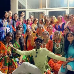 Backstage with a large group of performers in vibrant traditional costumes. I have experience choreographing for large-scale cultural shows and events.