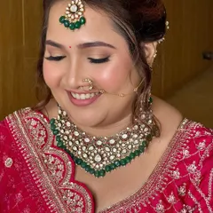 A close-up of this bride's radiant smile says it all. We chose a beautiful pink lehenga and paired it with soft, glowing makeup, defined eyes, and a matching pink lip for a fresh and classic wedding day look.