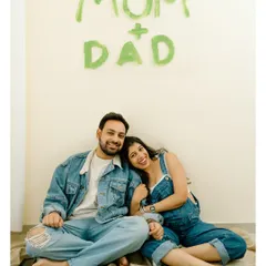 A beautiful, happy portrait of the parents-to-be. The hand-painted sign in the background makes it a perfect baby announcement photo.
