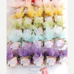 A rainbow of gift boxes for a baby shower, showing how we can coordinate the packaging with the colors of the candles and sachets inside for a complete look.