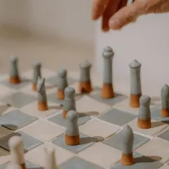 Art can also be playful. I loved the challenge of creating this complete ceramic chess set, where each piece is hand-sculpted and the board is made of custom-glazed terracotta and stoneware tiles.