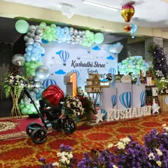 Another view of the hot air balloon setup, showing the full stage and floral arrangements.
