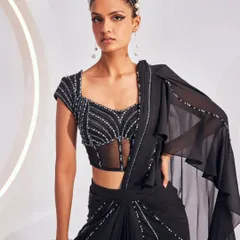 The Nerio Saree Set in classic black. This design features a pre-draped skirt and a beautifully structured corset blouse, embellished with linear patterns of beads for a sophisticated cocktail look.