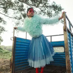 Another look from the 'SERPENTINE' series. The pose and composition were directed to feel both powerful and slightly off-kilter, emphasizing the contrast between the soft, layered tulle and the hard lines of the truck.