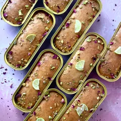 Zesty, sweet, and oh-so-soft. Our Lemon Vanilla tea cakes are topped with crushed pistachios, dried rose petals, and a slice of lime for a refreshing and aromatic treat.