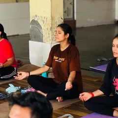 Three students in a moment of quiet meditation. We teach various techniques to help you find the stillness and clarity that lie within.