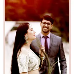A candid moment during a pre-wedding shoot in a lush green setting. The groom's admiring glance at the bride creates a natural and heartfelt portrait.