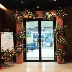 A grand entrance sets the tone for your entire event. For the Columbia Sportswear office opening, we created this lush floral archway, seamlessly integrating their brand's welcoming message with an elegant and impressive design that greets guests from the moment they arrive.