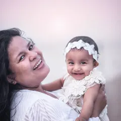A beautiful, happy portrait of a mother and her baby girl at the beach. The genuine smiles and soft sunset light make this a truly precious memory.