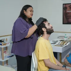 Here, one of my trained dermatologists is performing a targeted hair restoration treatment. Every procedure, whether it's GFC or QR678, begins with a thorough scalp analysis to ensure the treatment plan is perfectly suited to your specific hair loss concerns.
