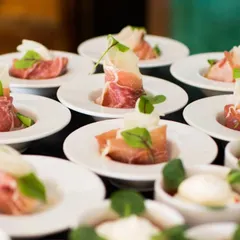 Prosciutto-wrapped melon is a classic Italian antipasto. The combination of sweet fruit and savory cured meat, presented on individual plates, is perfect for exclusive gatherings and wine-tasting events.