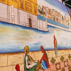 A close-up on the figures sitting by the water in the Golden Temple mural. Adding these human elements helps to bring the scene to life and tell a story.
