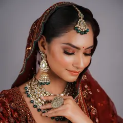 This profile view highlights the seamless blending and contouring techniques I teach, ensuring the bride looks perfect from every angle. Notice the subtle glow on the high points of the face.