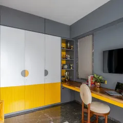 The brief for this boy's room was "tell us it's a boy's room without telling us." We used a cool palette of grey and white with a pop of school bus yellow, and added a standout wall mural of a cricketer to reflect his passion.
