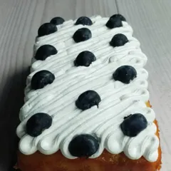 My Blueberry Tea Cake is a simple classic. The loaf is infused with fresh blueberries and topped with a light, airy whipped cream and more fresh berries.