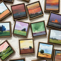 An overhead view of dozens of miniature landscape paintings scattered together. Each one captures a different sky, a different mood, a different fleeting moment in nature.